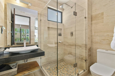 Each bathroom is designed with modern fixtures and a private attached toilet, offering both style and functionality for our guests!