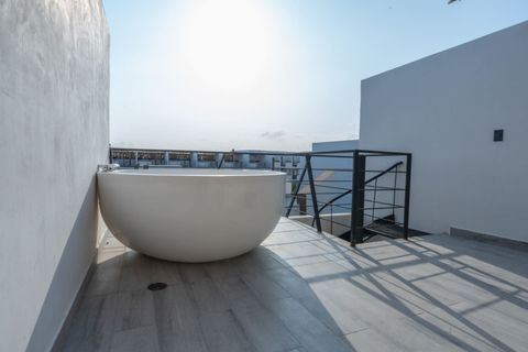Rooftop terrace with a large round jacuzzi, perfect for relaxing under the sun with panoramic views and modern minimalist design.