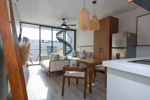 Bright studio with modern kitchen, wooden furniture, cozy bed and sofa, and private balcony . Natural tones and large windows complete the airy space.