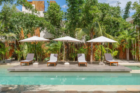 Lounge by the pool or take a swim in this beautiful shared space, with plenty of chairs for relaxing under the sun.