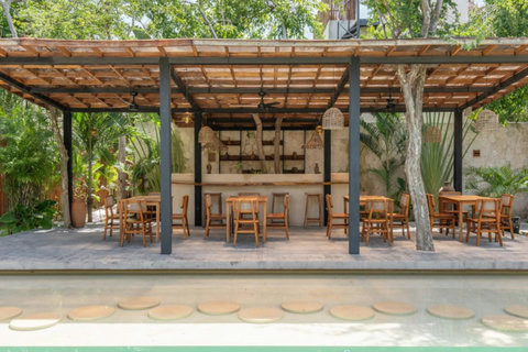 Perfect for morning coffee or evening cocktails, this cozy space brings you close to nature with lush greenery all around.