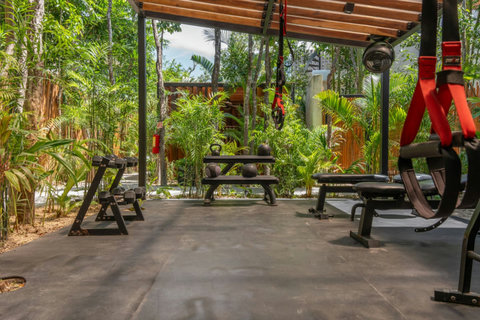 Keep up with your workout routine surrounded by nature in this open-air gym with quality equipment.