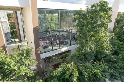Open spaces throughout the property are filled with lush greenery, creating a serene and calming atmosphere, perfect for enjoying Tulum's tropical beauty.