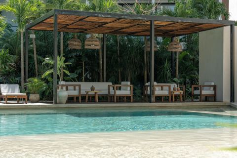 Take a dip in the shared pool or soak up the sun on comfortable lounge chairs, surrounded by trees and tropical vibes for the ultimate Tulum experience.