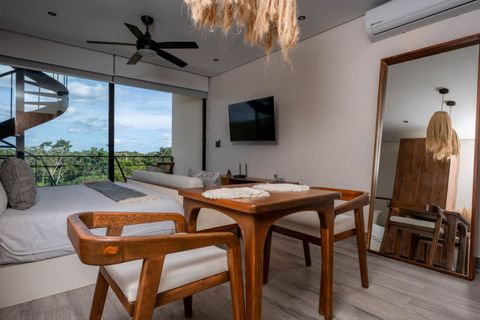 Relax and unwind in our elegantly appointed living room that blends contemporary design with a tropical vibe. Perfect for enjoying your morning coffee or an evening cocktail. Don't miss your blissful escape in Tulum!
