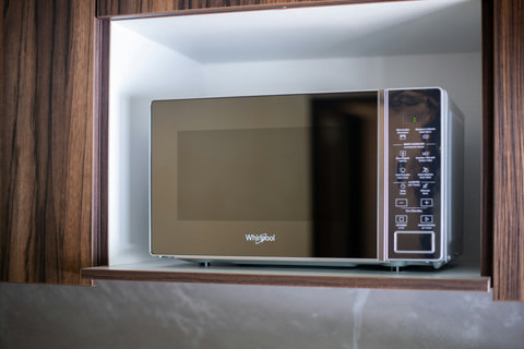 The kitchen is equipped with a sleek, modern Galanz microwave, perfect for quick and easy meal preparation.
