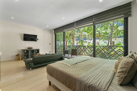 Cozy and bright space with a king bed, comfy sofa, and floor-to-ceiling windows. Enjoy garden views, modern decor, and a peaceful, relaxing vibe.