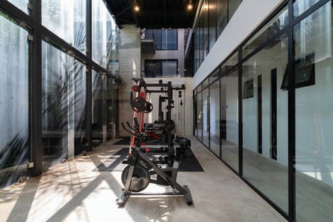 Fitness area with tropical views, modern equipment, and free weights—an open-air space perfect for energizing your workouts.