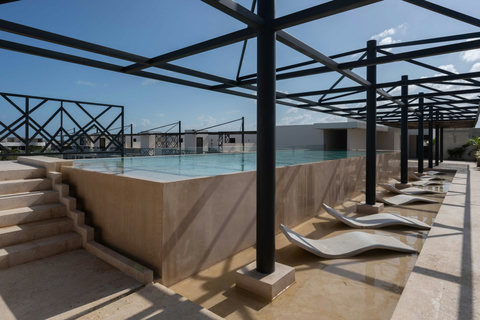 Modern rooftop with loungers and open-air design—ideal for relaxing under sunny skies and enjoying peaceful moments above the city.