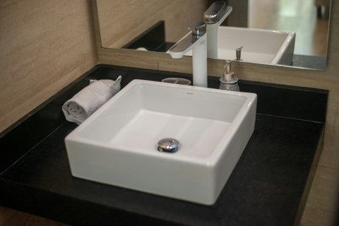 Modern vessel sink with sleek black granite countertop—clean, simple, and elegant design that adds a touch of style to your bathroom experience.