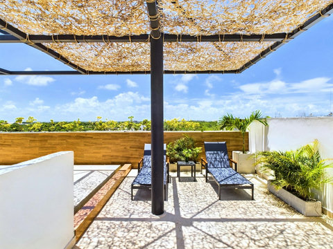 Experience pure relaxation at Palais Tulum’s terrace, with cozy armchairs perfect for basking in the sun and unwinding in a peaceful setting.