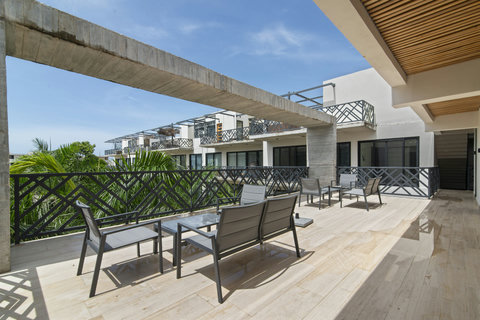 Bask in the calm of Palais Tulum’s terrace haven, where sun-kissed seating invites you to relax and recharge.