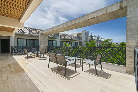 Soak in the tranquility of our serene terrace at Palais Tulum, designed for lounging, sunbathing, and quiet reflection.