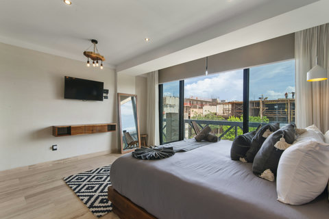 Enjoy a stylish bedroom with a cozy bed, flat-screen TV. Perfect for guests seeking modern comfort and relaxation!