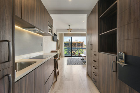 Enjoy cooking in a bright, modern kitchen with top appliances, natural light, and wooden touches—perfect for any length of stay.