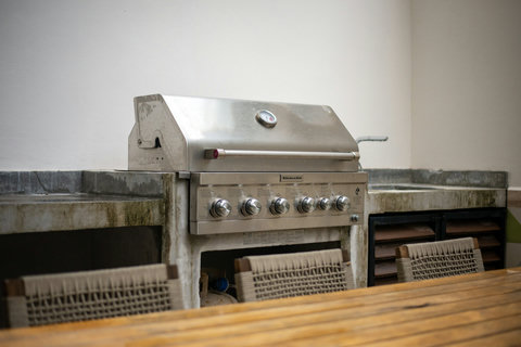 Modern BBQ area with a stainless steel KitchenAid grill and ample prep space. Great for enjoying Tulum evenings.