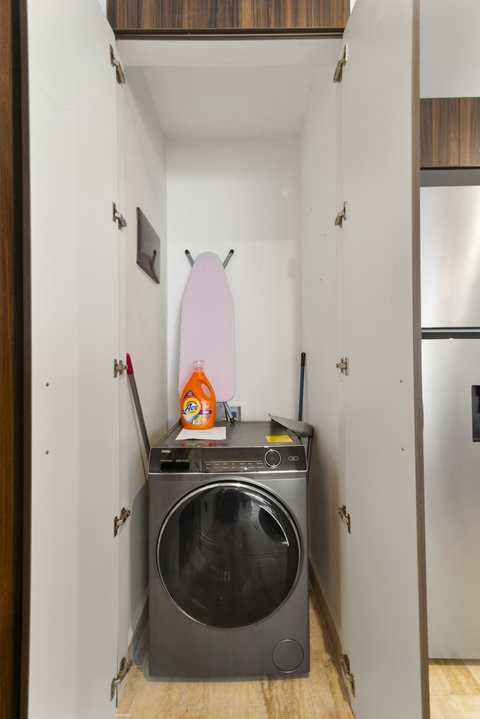 Modern washing machine with stainless steel finish, smart controls, and built-in design—blends perfectly into the laundry area for convenience and style.