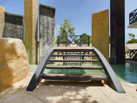 At the end of the gardens, a stylish bridge awaits—perfect for photos or just hanging out. Palais blends comfort and design for your stay.