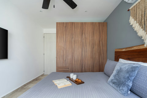 Spacious master bedroom featuring a king-size bed, A/C, Smart TV, blackout curtains, desk, and closet—perfect for relaxing, working, or enjoying a comfortable stay.