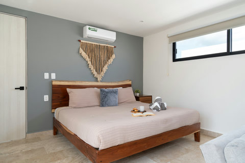 Beautiful king-size bed with plush bedding and soft pillows, offering the perfect blend of comfort and style for a restful night’s sleep in a serene atmosphere.