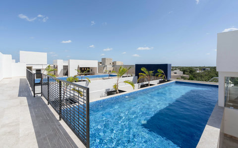 Relax in this peaceful shared rooftop pool, blending modern design with natural surroundings. Perfect for soaking up sunsets, enjoying the breeze, and embracing ultimate vacation vibes.