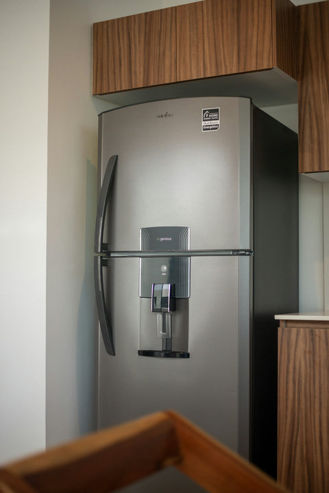 Spacious stainless steel refrigerator with water dispenser—perfect for extended stays.