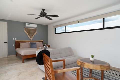 Bright and spacious third bedroom with a plush king-size bed, Smart TV, A/C, blackout curtains, and a large closet. Includes a cozy sofa bed, perfect for relaxing or accommodating extra guests.