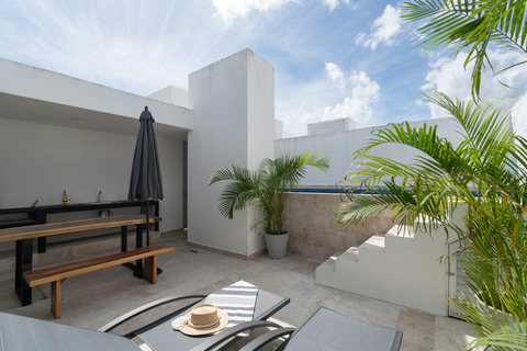 Enjoy a serene private terrace with a sparkling pool, sun loungers, and a charming breakfast table. Framed by palm trees, it’s the ideal place to relax and embrace the peaceful tropical vibe.