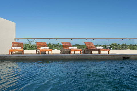 Enjoy this peaceful rooftop pool with sunny loungers and open views—perfect for relaxing, sunbathing, or cooling off after a day in town.