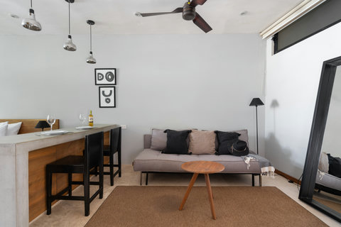 A spacious living area with a cozy, elegant sofa and a warm dining space—perfect for relaxing, sharing meals, and enjoying a comfortable setting