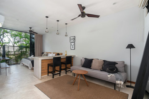 Spacious studio with a comfy sofa, a king-size bed, plenty of natural light, and large windows. Enjoy fast Wi-Fi, a ceiling fan, and stylish décor that creates a warm and inviting atmosphere.