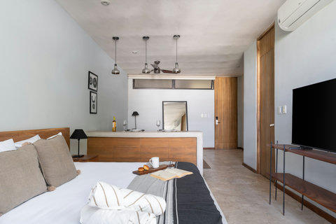Enjoy a luminous studio featuring a plush bed, stylish wood accents, and a crisp 50-inch TV—perfect for a cozy, contemporary stay with everything within reach.