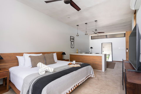 This bright studio offers a cozy king-size bed, elegant wooden details, and a modern 50-inch TV—creating a stylish, comfortable space with everything within easy reach.