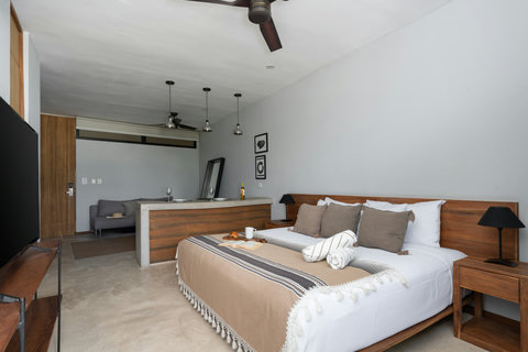 Enjoy a bright, modern studio featuring a plush king-size bed, warm wood touches, and a sleek 50-inch TV. A perfect space to relax, unwind, and feel completely at ease during your stay.