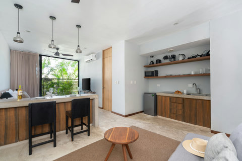 A bright kitchen and dining area featuring wide windows and everything you need for a great stay. This inviting space is designed for comfort, convenience, and enjoying meals in a warm atmosphere.