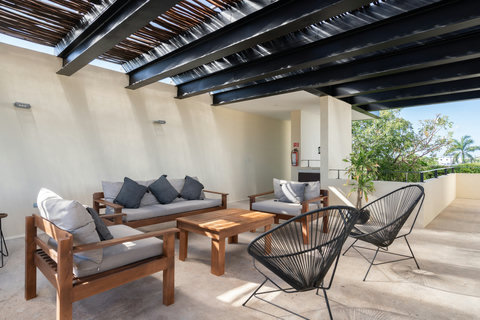 Relax in a charming rooftop lounge with comfortable seating and tables set right by the pool. Whether you're sunbathing, working, or enjoying a drink, this space is designed for comfort and ease.