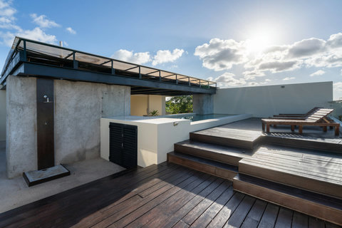 Relax on this bright rooftop featuring wooden loungers, a refreshing pool, and an open layout. With serene views and an outdoor shower, it’s the perfect place to unwind and enjoy calm moments.