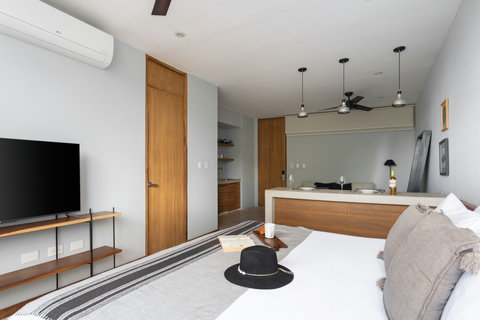Enjoy a bright, modern studio featuring a plush king-size bed, warm wooden accents, and a sleek 50-inch TV. It’s a cozy, stylish space designed to offer comfort, convenience, and a relaxing stay.