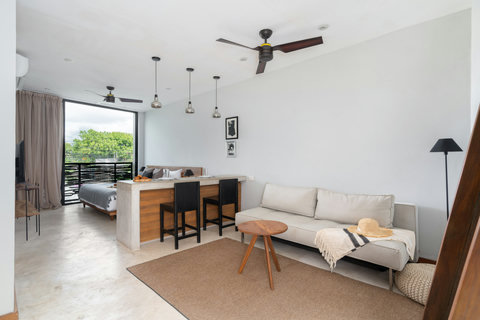 A warm lounge featuring a comfortable sofa, stylish coffee table, and large mirror. Ideal for reading, relaxing, or enjoying quiet moments in a welcoming space.