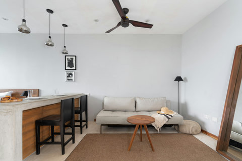 A stylish lounge with a comfy sofa, elegant coffee table, and large mirror. Perfect for reading, unwinding, or enjoying calm moments in a cozy atmosphere.