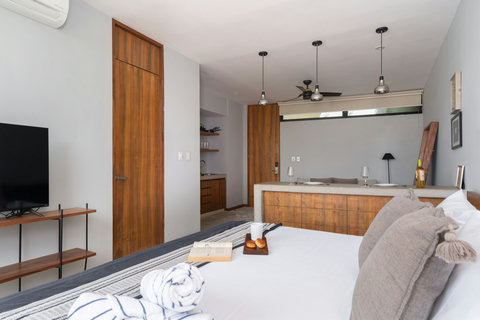 Inviting studio featuring a plush king bed, warm wood details, and a sleek 50-inch TV. This cozy, modern space keeps everything within reach for an easy and relaxing stay.