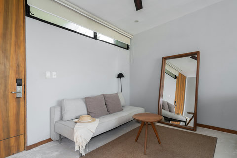 A stylish setup with an elegant sofa, large mirror, and charming coffee table creates a warm, cozy space. Ideal for unwinding, reading a book, or enjoying peaceful moments throughout the day.