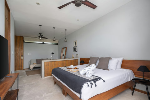 Enjoy a welcoming studio filled with natural light, a soft king bed, elegant wooden finishes, and a modern 50-inch TV. A stylish, calming space perfect for unwinding after a day of exploring.