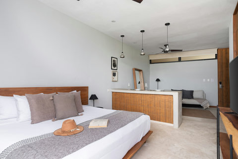 This modern studio blends comfort and style with a king-size bed, chic wooden accents, and a large 50" TV, perfect for a cozy, convenient stay.