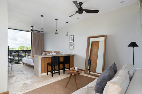 Relax in this airy studio featuring a king-size bed, cozy sofa, sunlit windows, fast Wi-Fi, and tasteful décor—a perfect spot for comfort and ease.