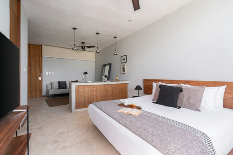 Relax in this inviting studio featuring a plush king bed, warm wood details, and a modern 50-inch TV—a comfortable, convenient space for an easy stay.