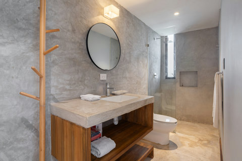 Enjoy a stylish bathroom with a modern sink, large mirror, and refreshing rain shower—designed for comfort, relaxation, and an effortless daily routine.