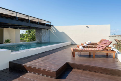 Unwind on this beautiful rooftop terrace with comfy sunloungers, pool views, and wide-open skies—a serene spot to soak up the sun and enjoy peaceful outdoor moments.
