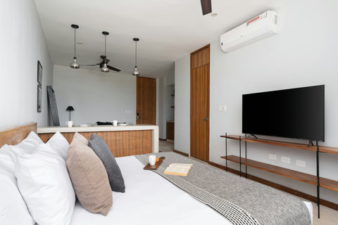 This bright studio offers a comfortable king bed, stylish wooden touches, and a 50-inch TV—a cozy, contemporary space with everything you need for a relaxing stay.