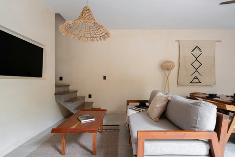 Enjoy a cozy living area with a sleek wooden coffee table, minimalist décor, and a light-filled ambiance that blends comfort and style effortlessly.